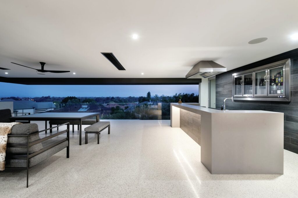Modern balcony area with a concrete bar on a white polished concrete floor