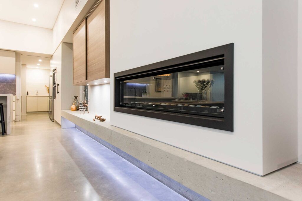 Modern fireplace embedded in a painted concrete wall